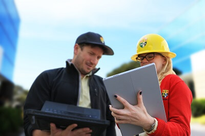 Photo of two NABCEP accredited solar professionals discussing solar panel project