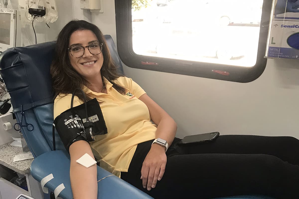 Photo of Community Developer Brenna Alexandre smiling inside San Diego Blood Bank truck