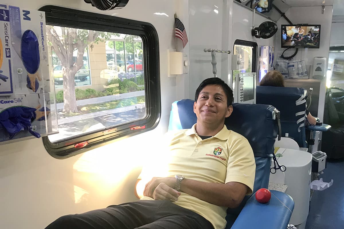 Photo of Matt Reynolds smiling inside San Diego Blood Bank truck