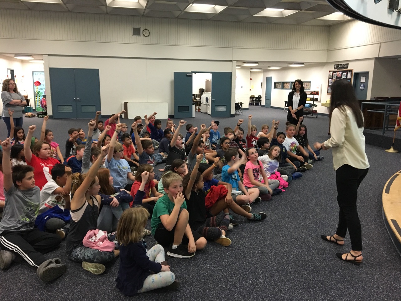 Photo of Sullivan Solar Power community development manager teaching elementary school students about solar power